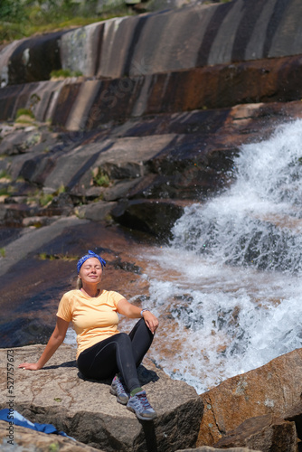 girl tourist admiring the waterfall in Ergaki nature park