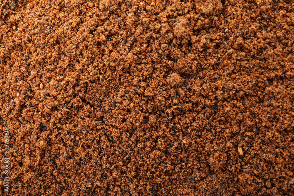 Nutmeg powder on whole background, close up Nutmeg powder on whole background, close up