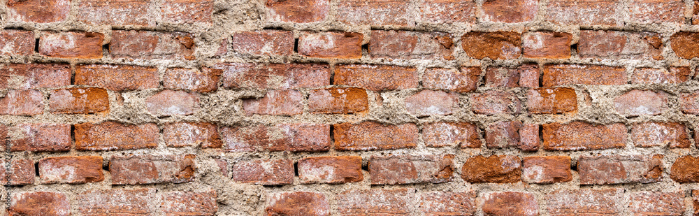 Naklejka premium Faktura starego ceglanego muru z naturalnymi ubytkami. old brick wall