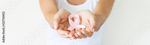 Woman with pink ribbon symbol of breast cancer awareness month. Horizontal long banner for web design