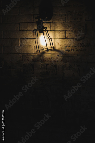 dim light lamp on the brick wall for dark rustic background
