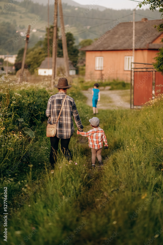 Obraz premium Mother with her little son in the park for a walk in summer. Active lifestyle with the baby in the summer.