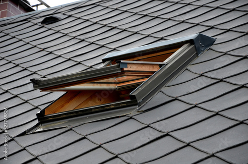gray roof tiles with windows square slate template. square grid pattern. the lower edge of the roof is formed by a metal strip for framing  better tearing off  layer of snow heat transfer through  