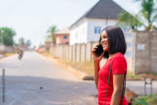 pretty african lady making a phone call smiling © Confidence