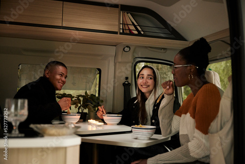 Friends having meal in camper van