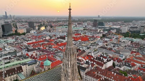Vienna aerial skyline at sunset. Stephen's Cathedral, flying above Vienna, capital of Austria, famous tourist landmark of gothic cathedral in the city centre photo