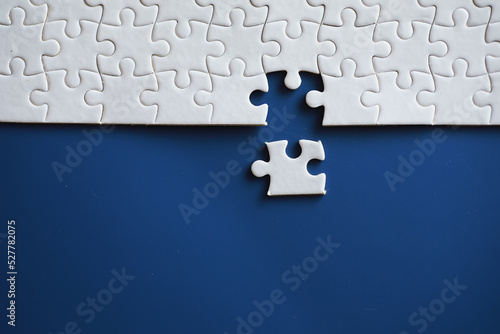 Clean puzzle elements on the background. Empty puzzle piece on the table. Teamwork concept.