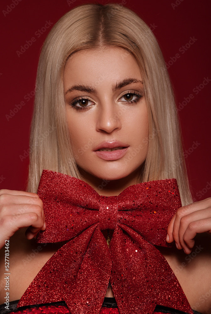 Beautiful woman portrait, holding a red bow Beautiful woman portrait, holding a red bow