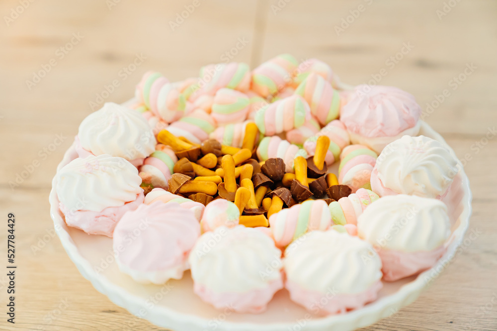 marshmallows and cookies mushrooms with chocolate on a plate. marshmallows and cookies mushrooms with chocolate on a plate.