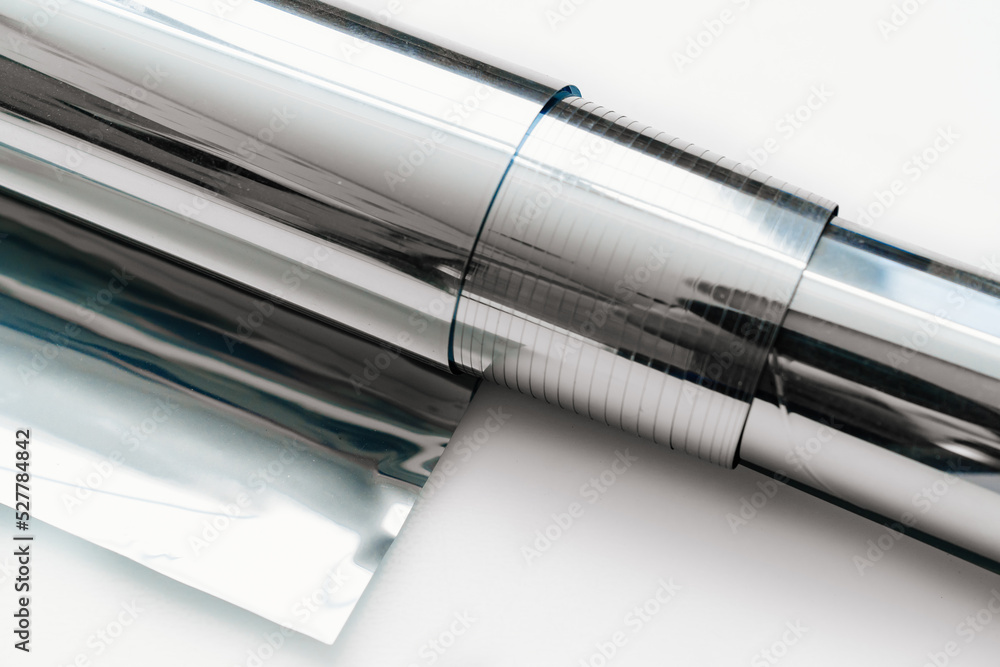 Fototapeta premium a roll of foil for baking on a white background.