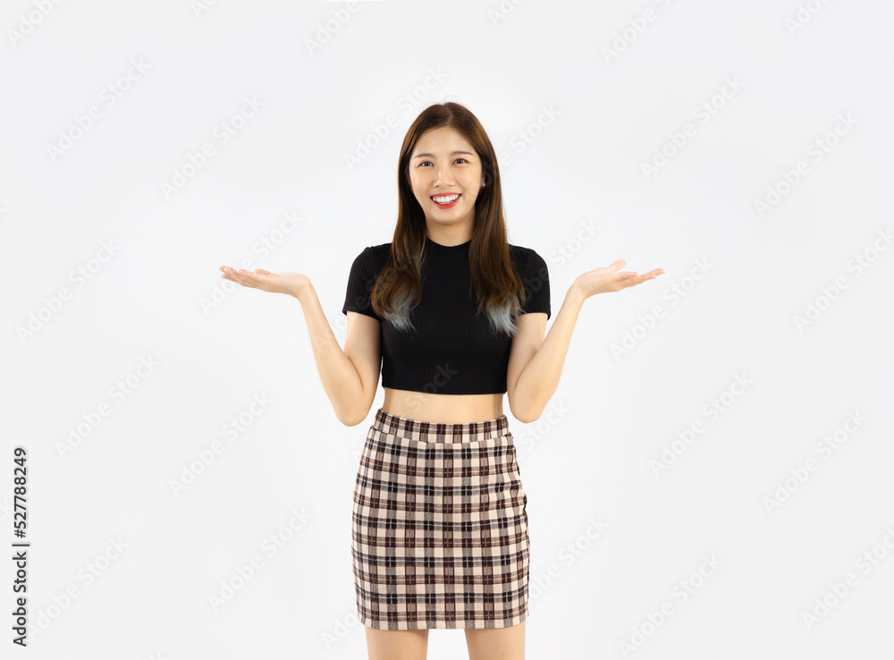 Asian woman in black crop t-shirt posing hand pointing on white background. Asian woman in black crop t-shirt posing hand pointing on white background.
