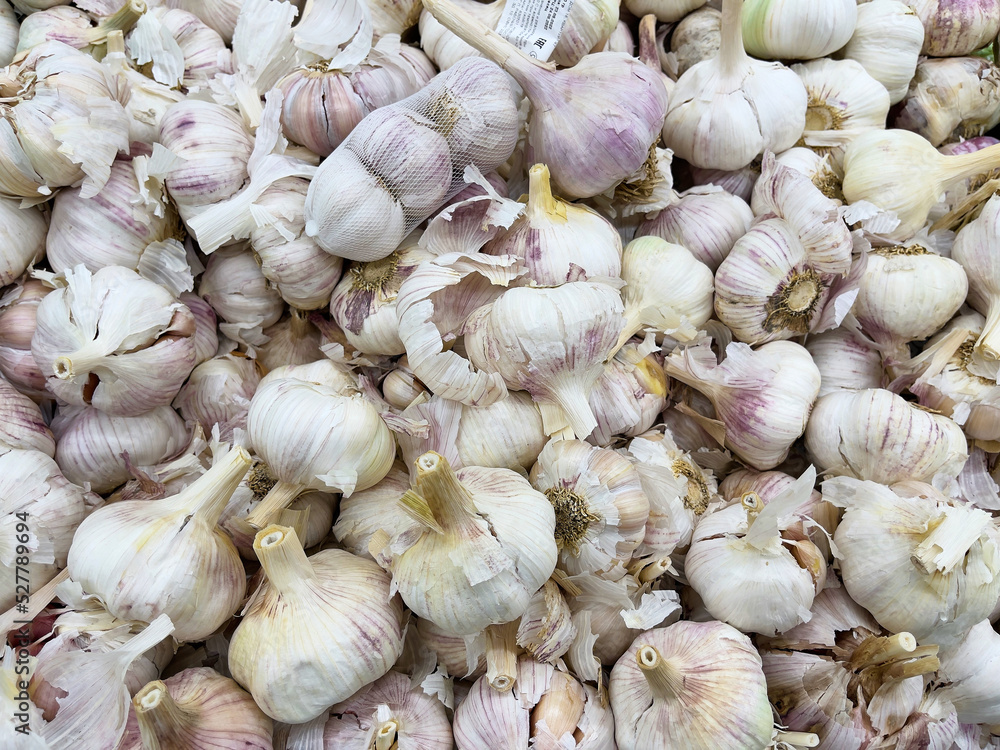 A close-up view of garlic in a store. A close-up view of garlic in a store.