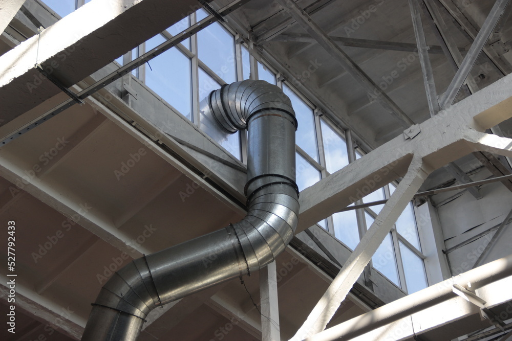 Curved ventilation pipe passing under the roof of the workshop Curved ventilation pipe passing under the roof of the workshop