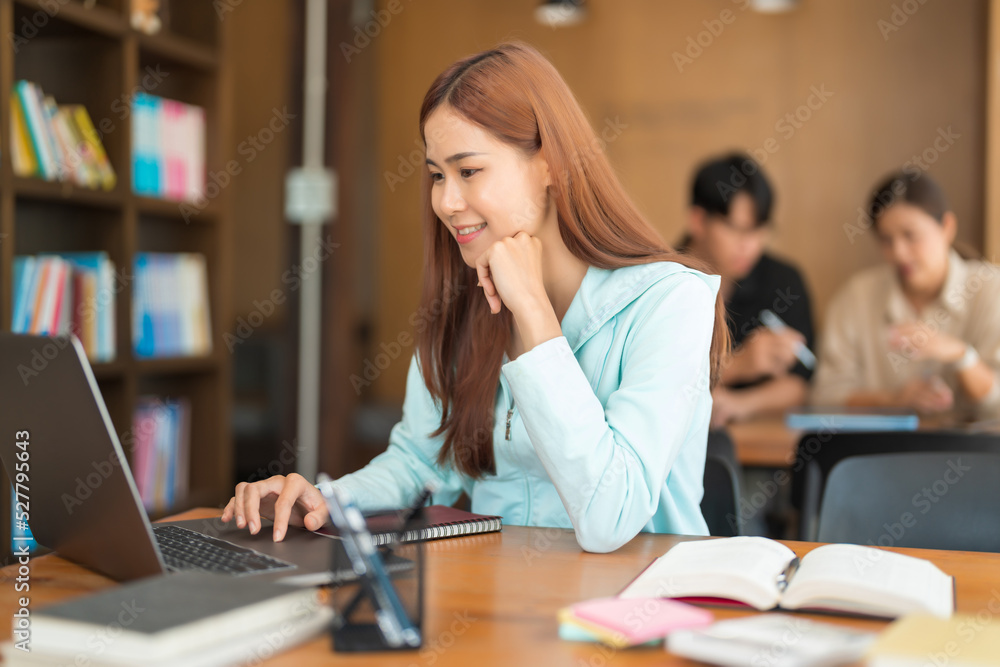 Education concept, Teenage girl use laptop to surf social media to relaxation after study tutorial Education concept, Teenage girl use laptop to surf social media to relaxation after study tutorial