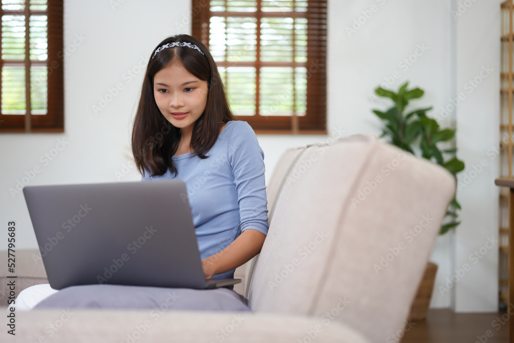 Work from home concept, Business women is typing financial report while working remotely at home Work from home concept, Business women is typing financial report while working remotely at home