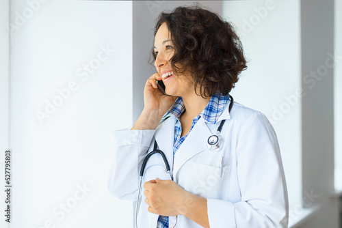 Laughing doctor with stethoscope having a coffee 