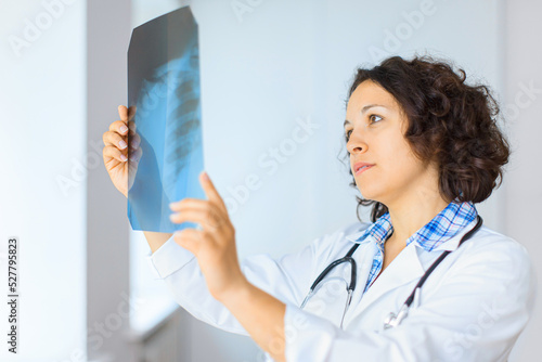 Female doctor looking at X-rays 