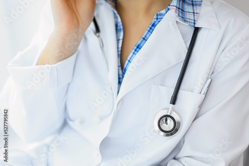 Female doctor with stethoscope on the phone