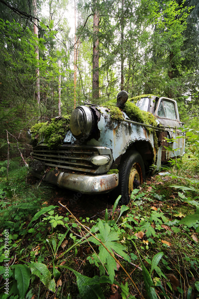 Fototapeta premium Old, forgotten car in Finnish forest. 