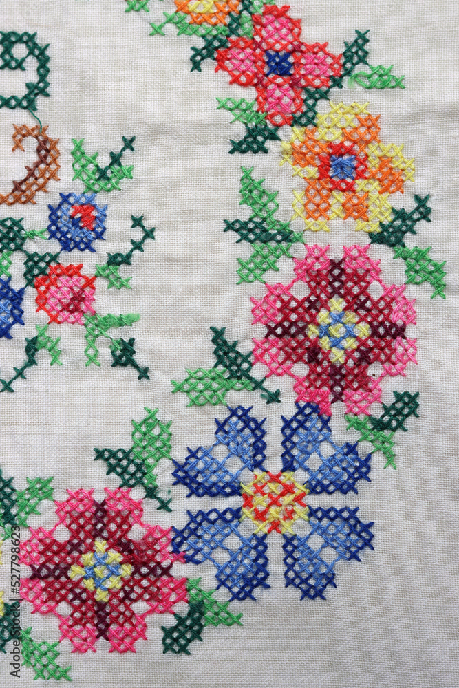 Embroidered table cloth close up photo. Beautiful flower pattern detailed photo. Stitch embroidery design. 
