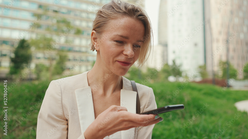 Businesswoman uses cellphone, sends voice message Businesswoman uses cellphone, sends voice message