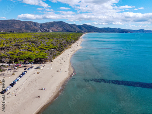 Drone view of Alberese's beach during a sunny summer day (in a southerly direction). Sea waves and sandy beach in Alberese, Maremma National Park in the beautiful Tuscany territory. photo