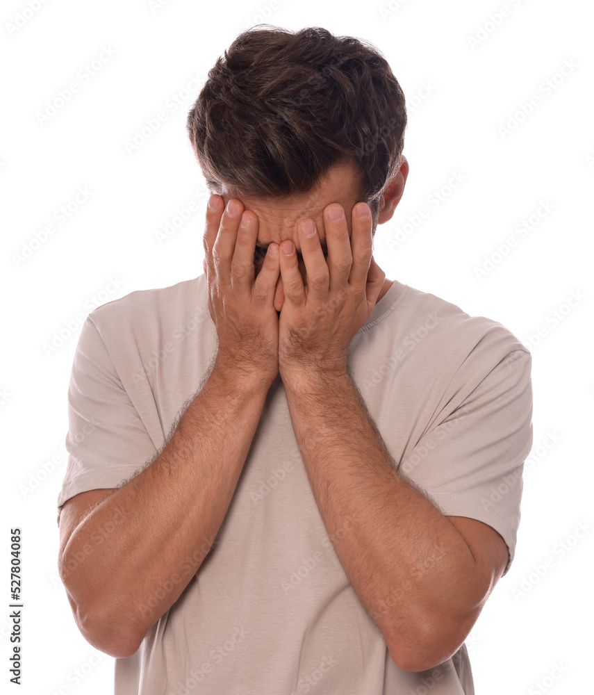 Upset man covering face with hands on white background Upset man covering face with hands on white background