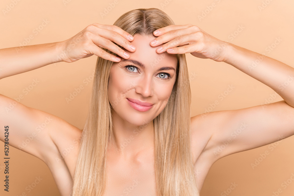 Photo of charming lady have oily dry face skin need hydration peeling lotion isolated over pastel beige color background Photo of charming lady have oily dry face skin need hydration peeling lotion isolated over pastel beige color background