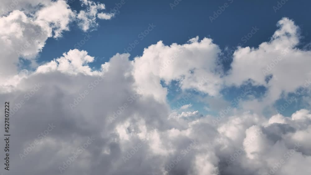 Real Flight through an amazingly beautiful cloudy landscape. Picturesque timelapse of white fluffy clouds moving gently across a clear blue sky. High above the ground where the clouds form Real Flight through an amazingly beautiful cloudy landscape. Picturesque timelapse of white fluffy clouds moving gently across a clear blue sky. High above the ground where the clouds form