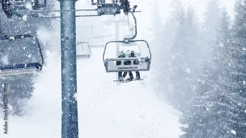 Heavy snowfall at alpine resort ski lift ropeway
