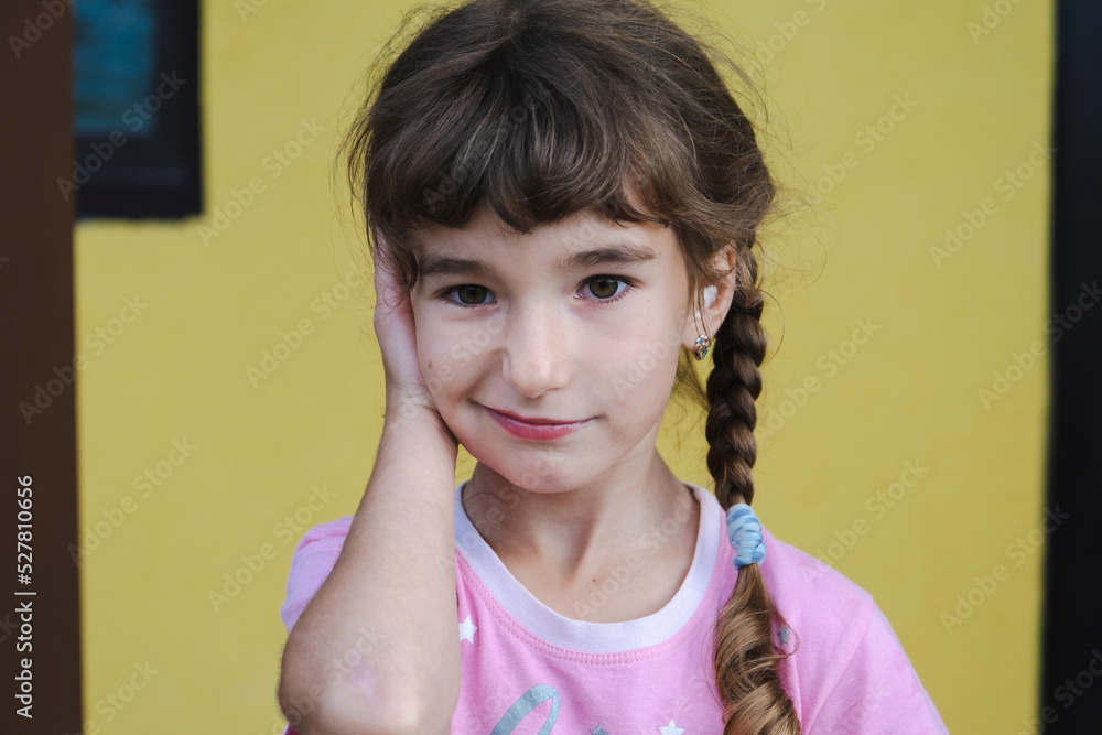 Girl with a warming therapeutic cotton swab in the ear with a sad and