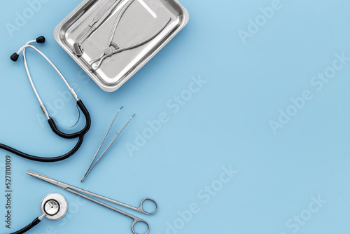 Dental or surgical steel instruments with stethoscope. Healthcare background photo
