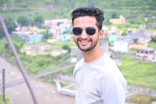 a indian boy happily, smiley face with sunglasses.