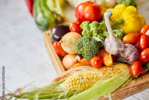 Wooden box with different fresh farm vegetables on the white background, Autumn harvest and healthy organic bio food concept, Garden produce and harvested vegetable