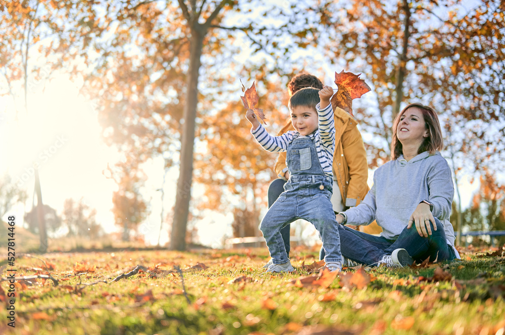 Lesbian family with son in autumn park Lesbian family with son in autumn park