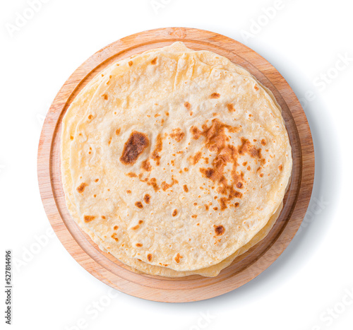 Traditional chapati cakes on a blackboard are isolated on a white background in close-up. Indian cuisine. Top view photo