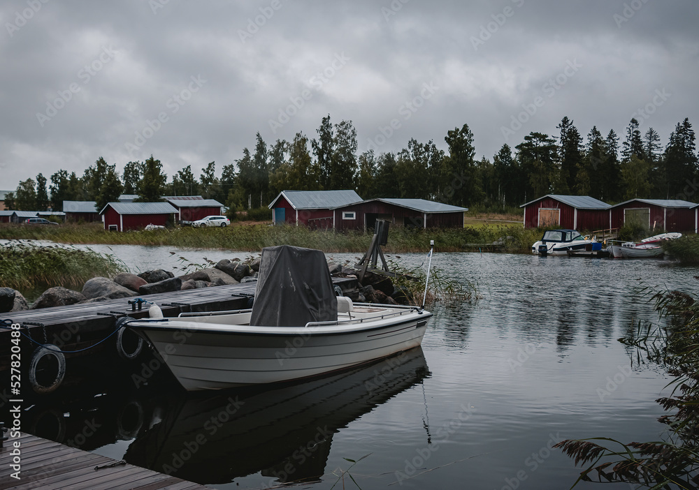 fishing boats and wooden red huts. view of the lake.