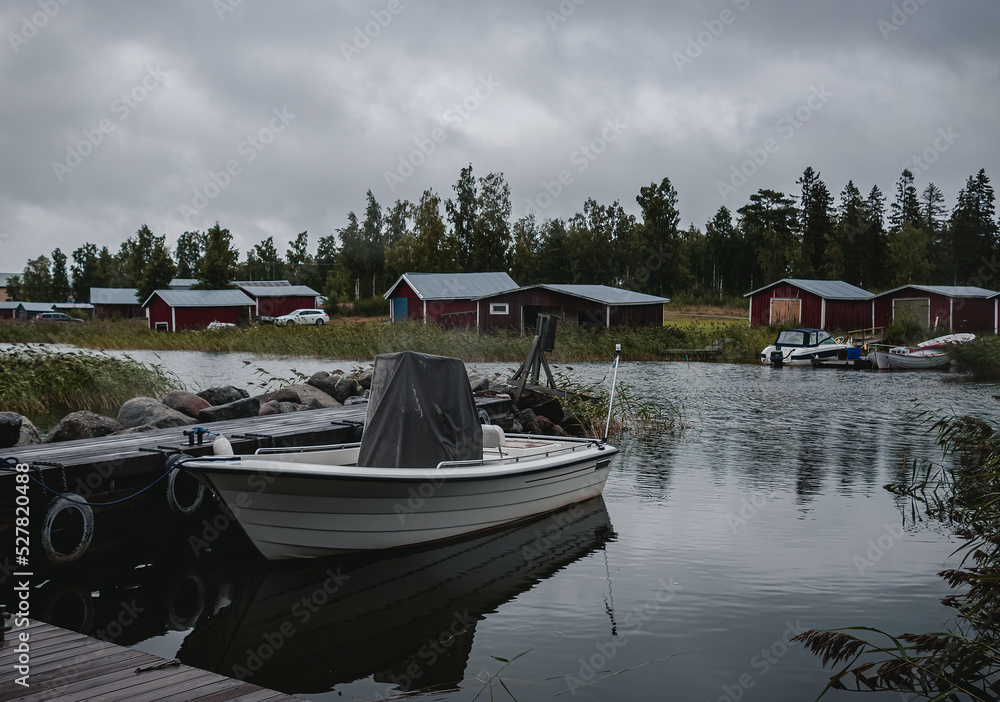 Obraz premium fishing boats and wooden red huts. view of the lake.
