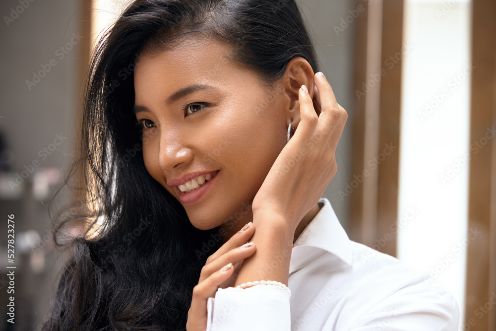 Beautiful Asian Woman. Happy Young Girl Touch her Clean Skin and Looking Away. Concept of Face Skin Care and Beauty Beautiful Asian Woman. Happy Young Girl Touch her Clean Skin and Looking Away. Concept of Face Skin Care and Beauty