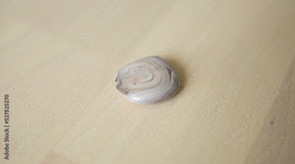 colored stone, sand jasper lies on a wooden surface.astrology, talisman for the zodiac signs Pisces, Virgo and Taurus colored stone, sand jasper lies on a wooden surface.astrology, talisman for the zodiac signs Pisces, Virgo and Taurus