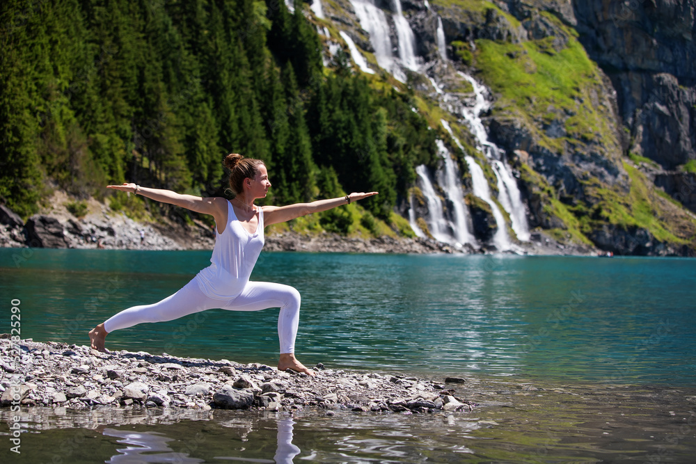 A woman practices yoga in the mountains A woman practices yoga in the mountains