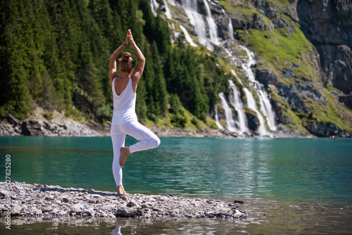 A woman practices yoga in the mountains
