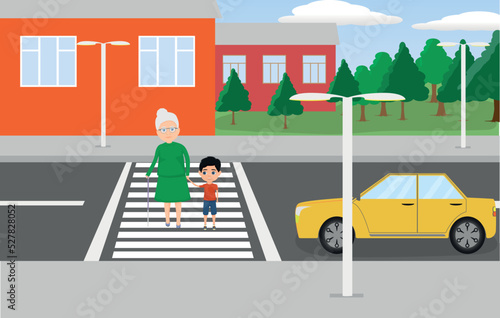 The boy helps the old woman to cross the road.