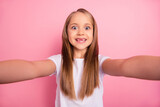Photo of excited positive girl toothy toothless front smile make selfie isolated on pink color background