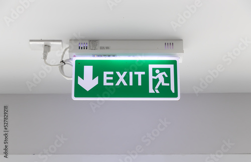 Fire exit signs installed on the wall of the building.