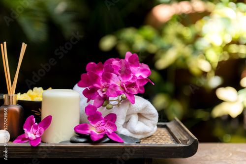 Thai Spa Treatments aroma therapy salt and sugar scrub massage with purple orchid flower on backboard with candle. Thailand. Healthy Concept