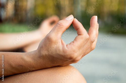 Young woman practicing yoga and meditation - hands close up. © Liaisan