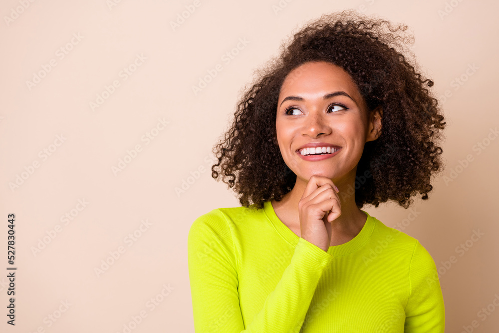 Close up photo of cute girl wavy hair touch chin dreamy look empty space dressed trendy yellow clothes isolated on beige color background Close up photo of cute girl wavy hair touch chin dreamy look empty space dressed trendy yellow clothes isolated on beige color background