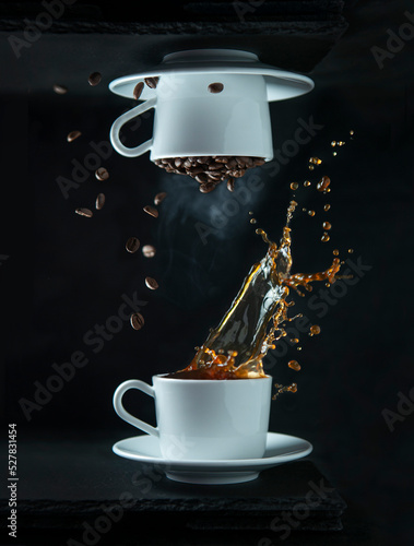 Two cups of coffee with splashed and coffee beans levitation with black background, selective focus