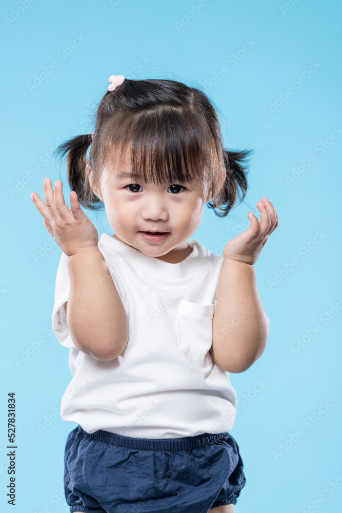 Little girl touch her face over blue background Little girl touch her face over blue background